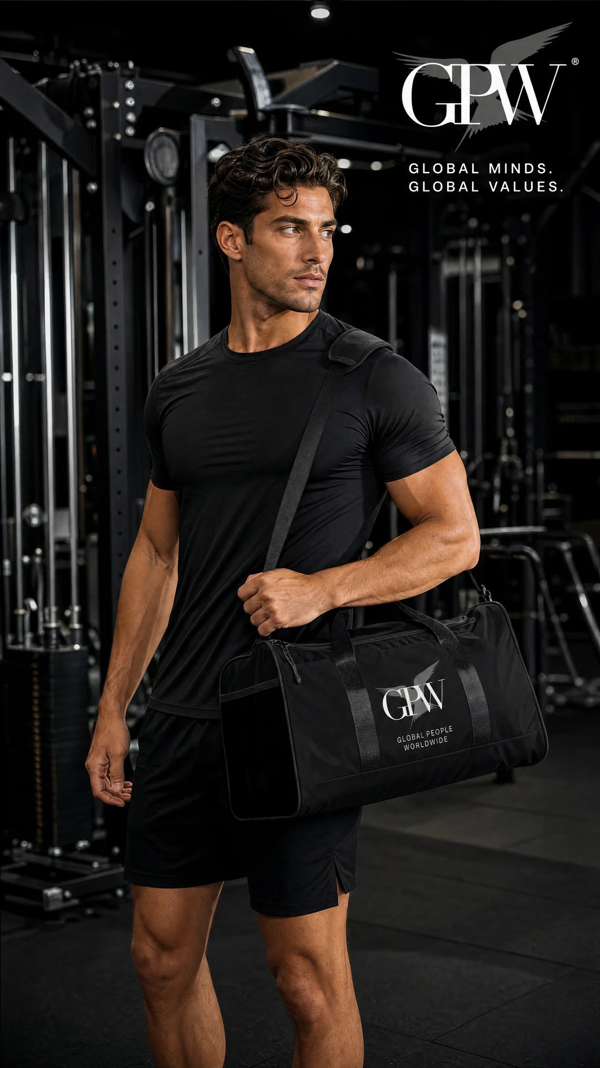 A muscular man in a black athletic t-shirt and shorts walks through a gym while carrying a black GPW duffel bag over his shoulder. The GPW logo is visible on the bag and as an overlay in the top right corner.